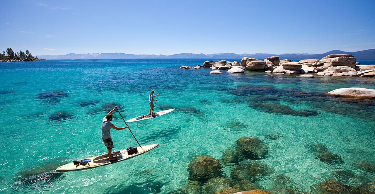 two people paddle boarding on Lake Tahoe